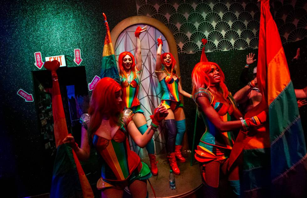 Costumed performers dance in the Queen Bar during the second day of the Electric Daisy Carnival ...
