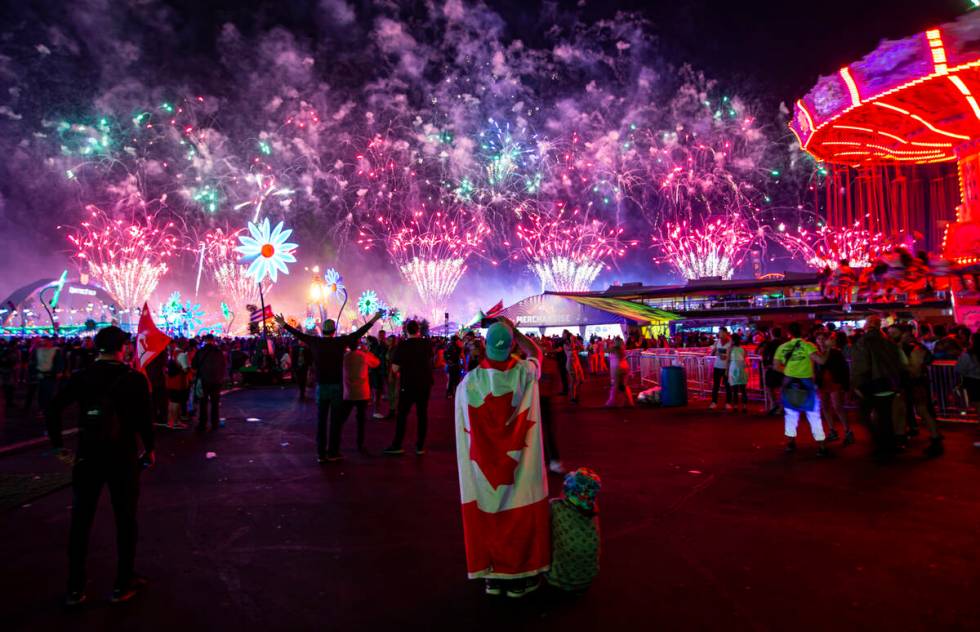 Attendees watch as fireworks go off across the festival grounds during the second day of the El ...