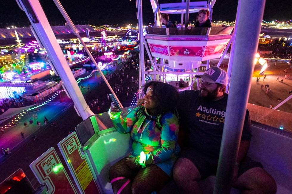 Asha Copper, left, and Zack Correll, both of Charleston, S.C., take in the sights from a ferris ...