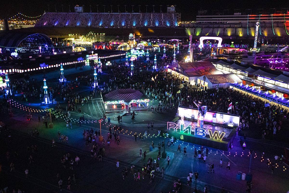 Attendees walk around the festival grounds during the first day of the Electric Daisy Carnival ...