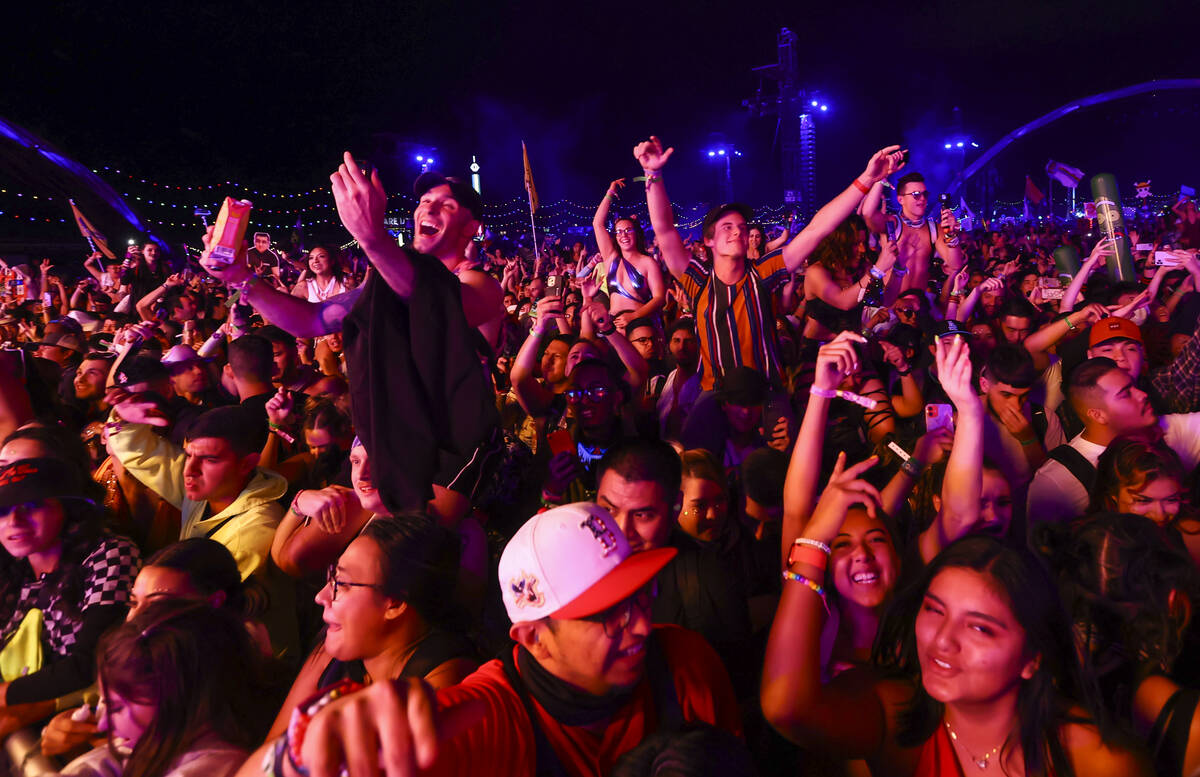Attendees dance and sing as The Chainsmokers perform at the Kinetic Field stage during the firs ...