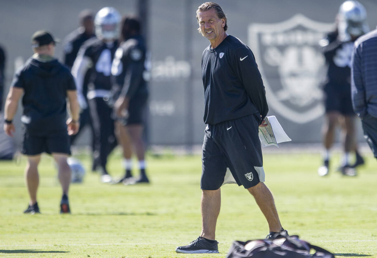 Raiders offensive coordinator Greg Olson walks the field during a practice session at the Raide ...