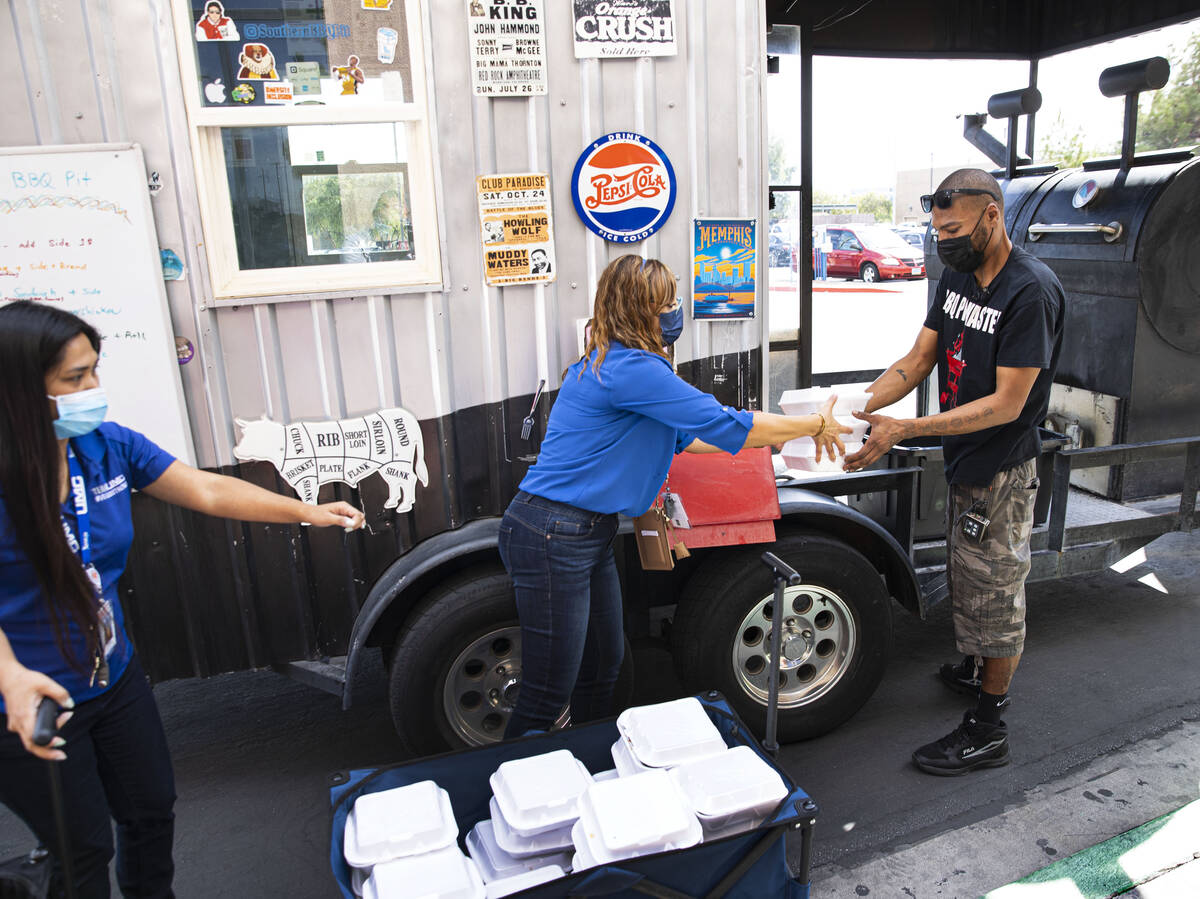 A local chef and food truck owner Darrell Martin, right, delivers meals and reunite with the UM ...