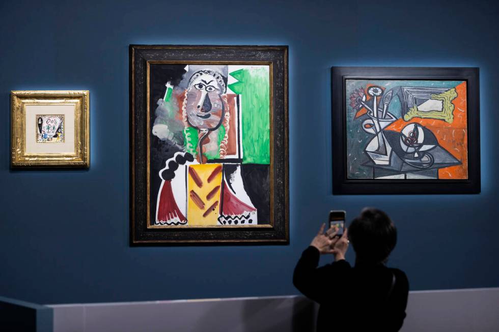Guests take photos during an auction held by Sotheby's featuring eleven of Pablo Picasso&#x2019 ...