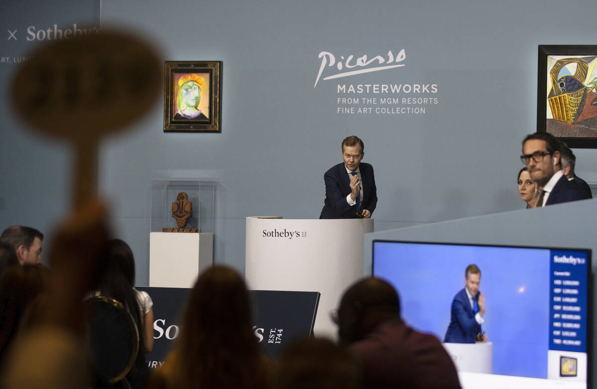 Oliver Barker, middle, takes bids during an auction held by Sotheby's featuring eleven of Pablo ...