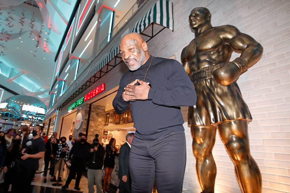 Former boxer Mike Tyson greets people in front of newly unveiled his stature at Mulberry Street ...