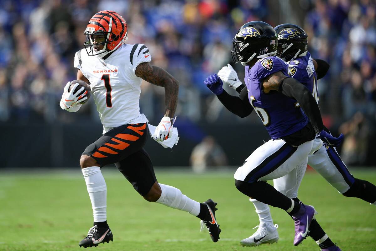 Cincinnati Bengals wide receiver Ja'Marr Chase (1) runs with the ball against Baltimore Ravens ...