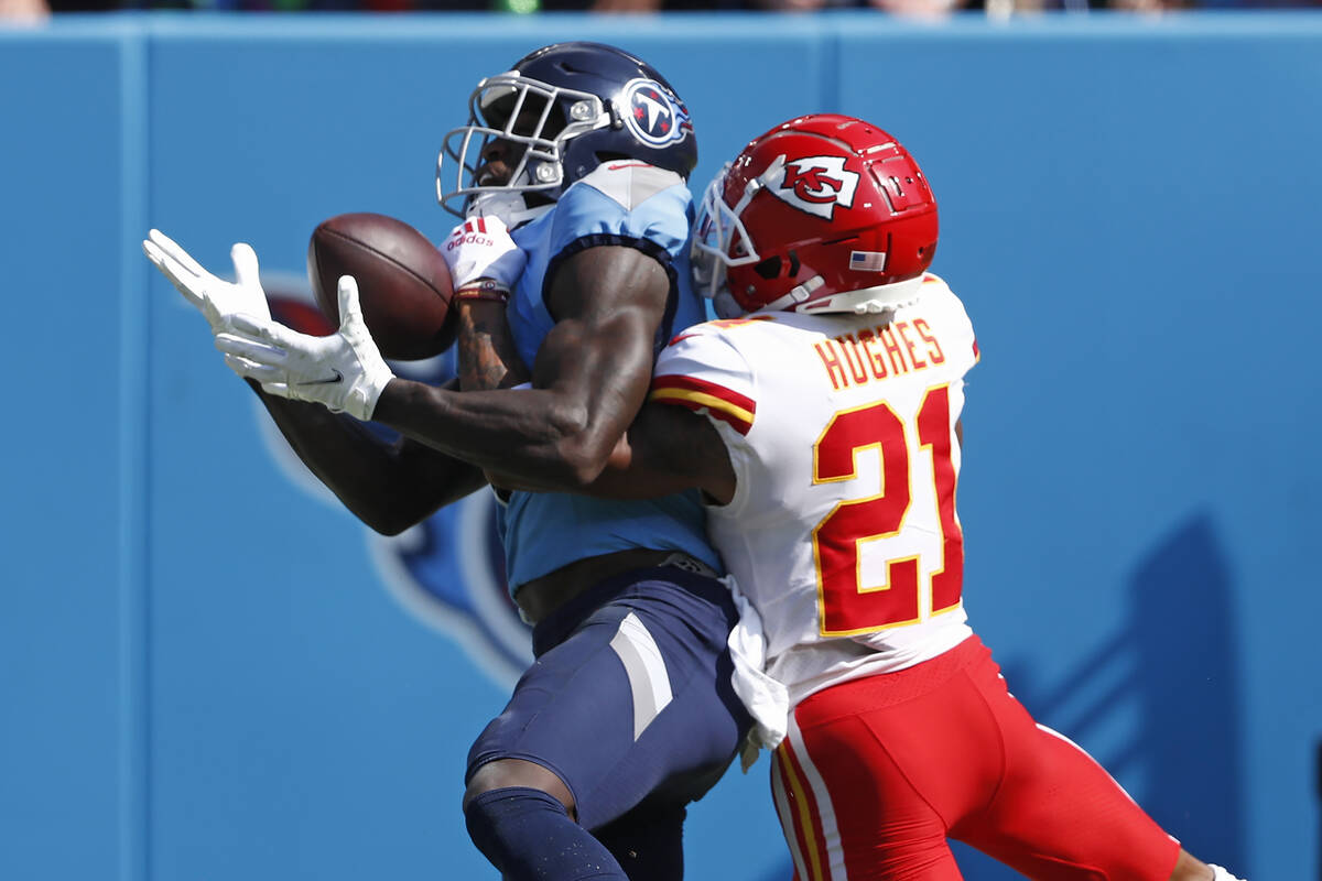 Tennessee Titans wide receiver A.J. Brown, left, catches a touchdown pass as he is defended by ...