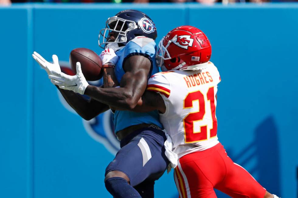 Tennessee Titans wide receiver A.J. Brown, left, catches a touchdown pass as he is defended by ...