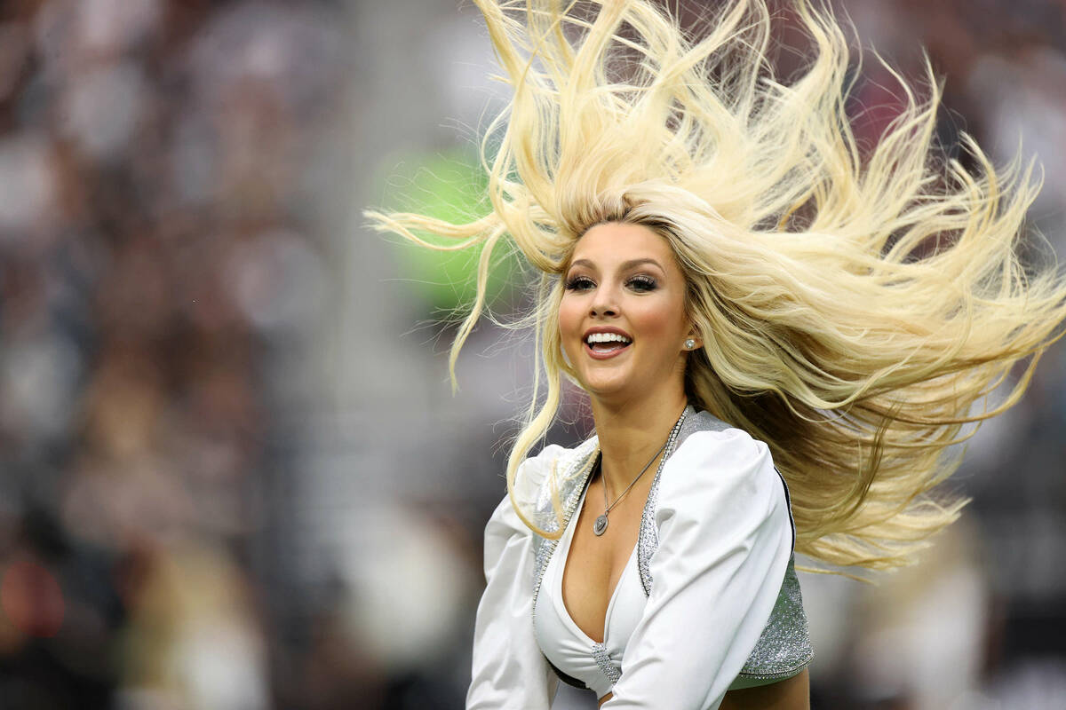 A cheerleader performs during the second half of an NFL football game between the Raiders and t ...