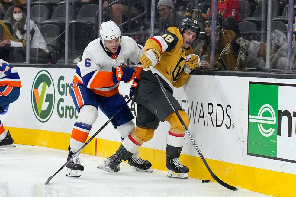 New York Islanders defenseman Ryan Pulock (6) and Vegas Golden Knights Peyton Krebs fight for t ...
