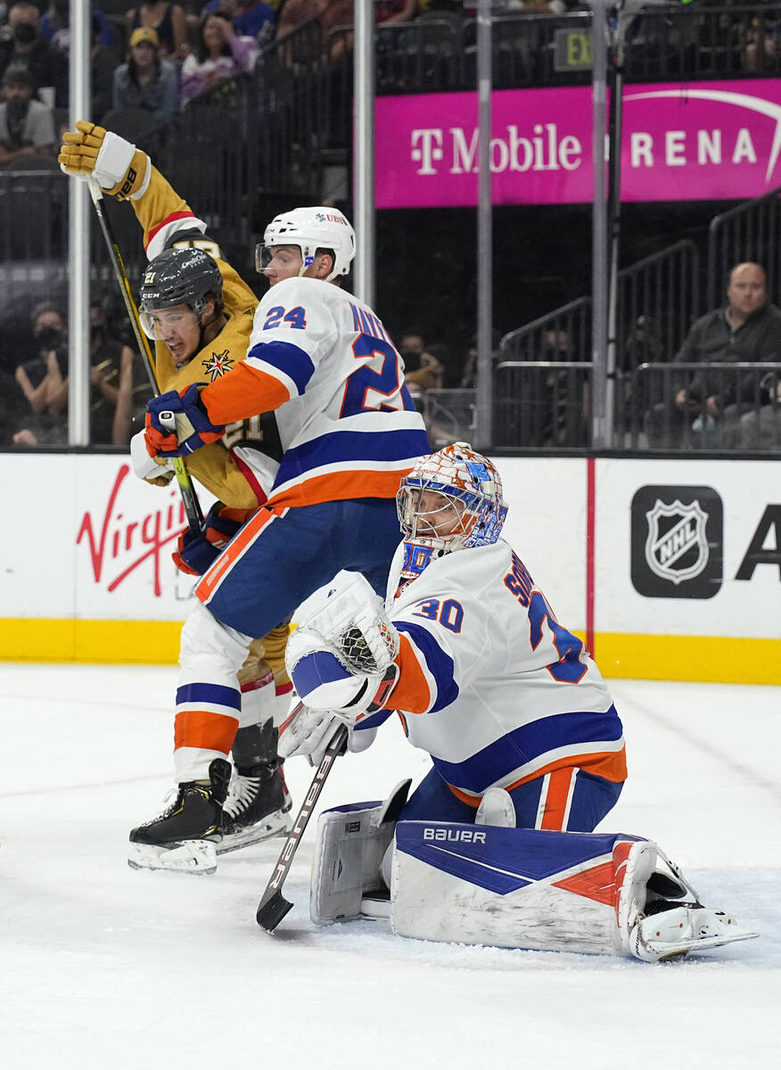 New York Islanders goaltender Ilya Sorokin (30) makes the save as defenseman Scott Mayfield (24 ...