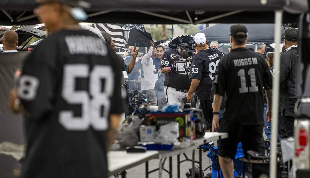 Raiders fans enjoy some tailgating before the first half of an NFL game at Allegiant Stadium on ...