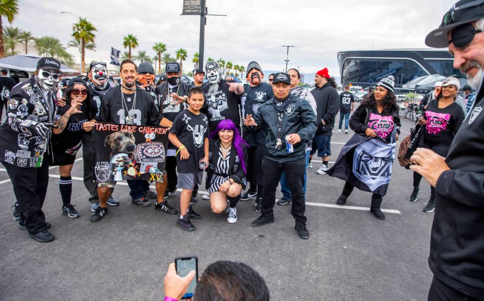 Raiders fans gather for a group photo in tailgating before the first half of an NFL game at All ...
