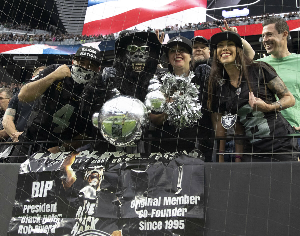 Raiders fans cheer in the Black Hole during the fourth quarter of an NFL football game against ...