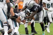 Philadelphia Eagles quarterback Jalen Hurts (1) is sacked by Raiders defensive tackle Quinton J ...