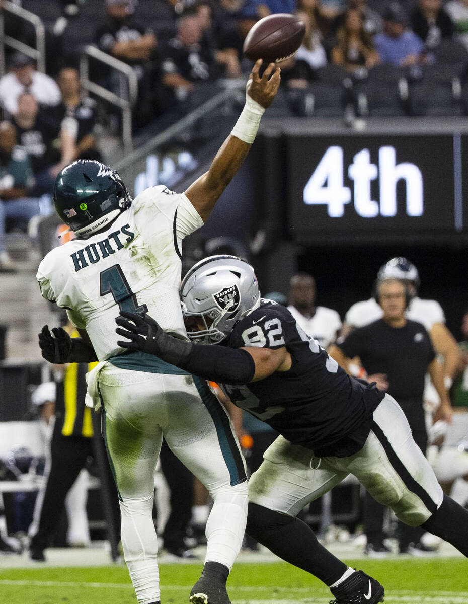Philadelphia Eagles quarterback Jalen Hurts (1) is hit by Raiders defensive end Solomon Thomas ...