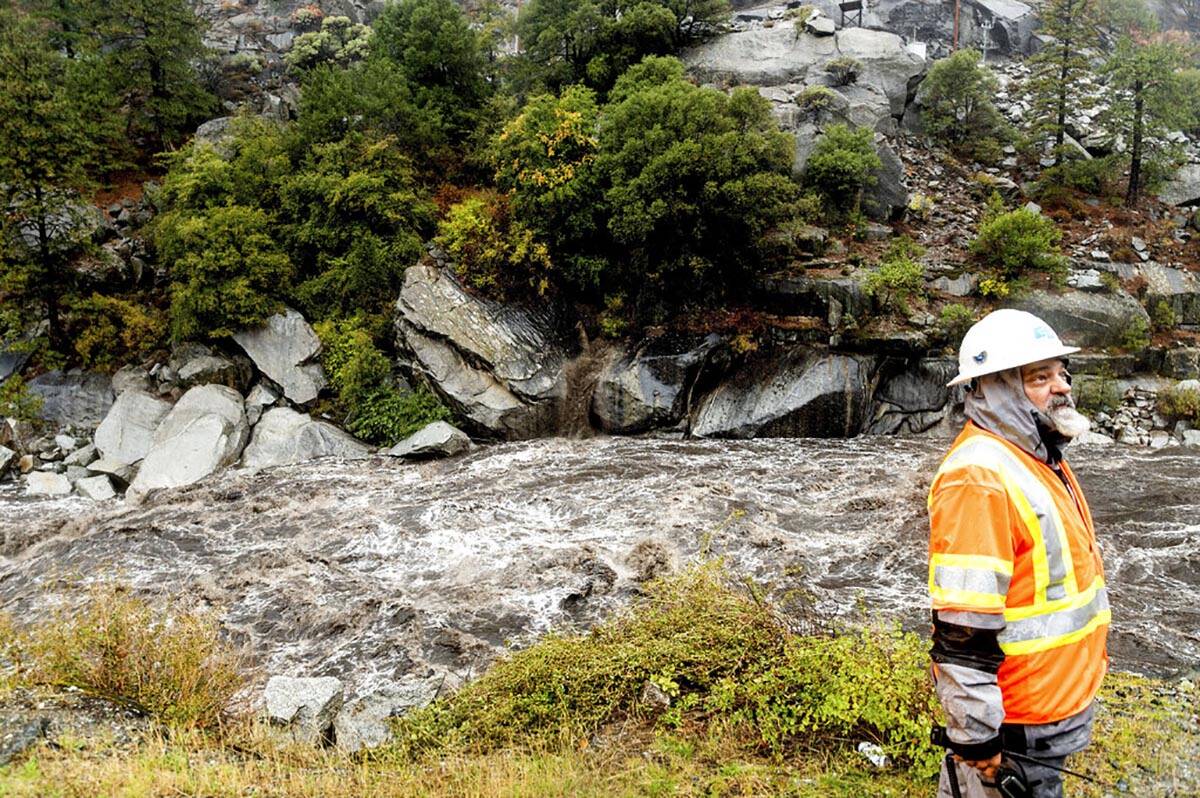 Caltrans maintenance supervisor Matt Martin surveys a landslide covering Highway 70 in the Dixi ...