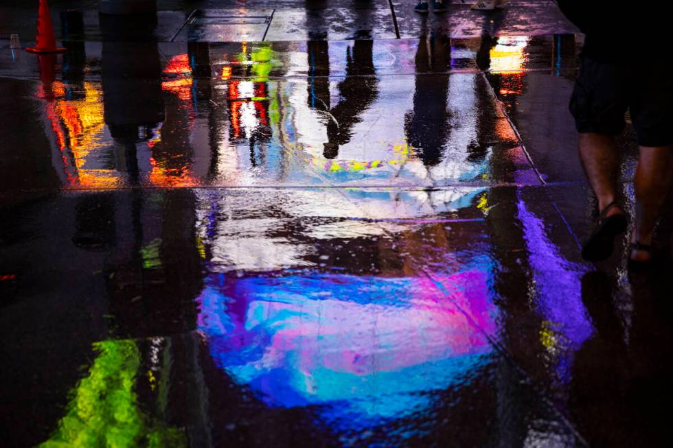Reflections in the water on Fremont Street as rain comes down in downtown Las Vegas on Monday, ...