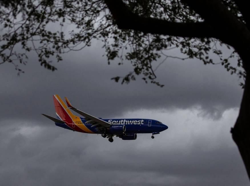 A Southwest Airlines plane prepares to land under a dark sky at McCarran Airport, on Monday, Oc ...