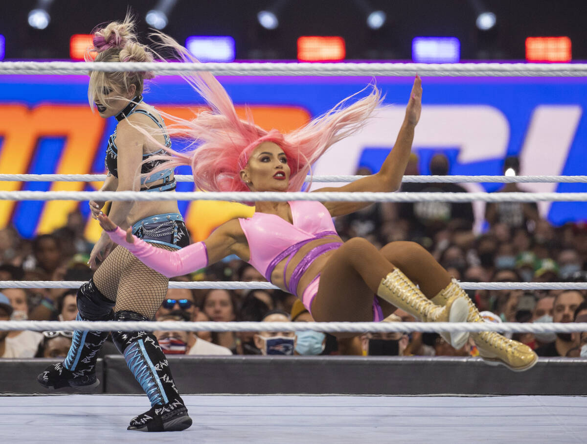 Alexa Bliss , left, upends Eva Marie in their match during WWE SummerSlam 2021 at Allegiant Sta ...