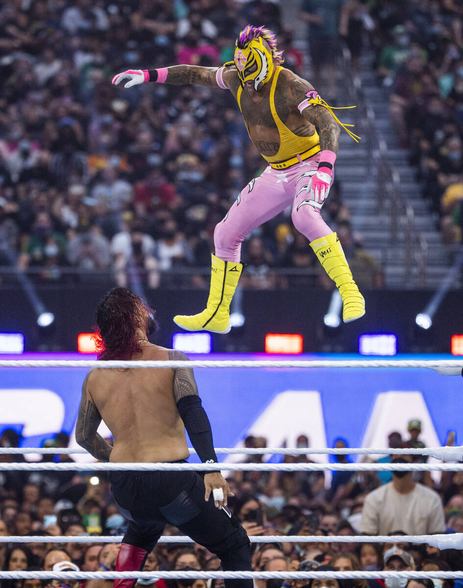 Jey Uso, left, looks up as Dominik Mysterio jumps down onto him in the SmackDown Tag Team Champ ...