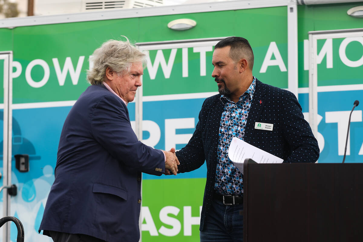 Clark County Commissioner Tick Segerblom, left, shakes hands with Shawn Seipler, Clean the Worl ...