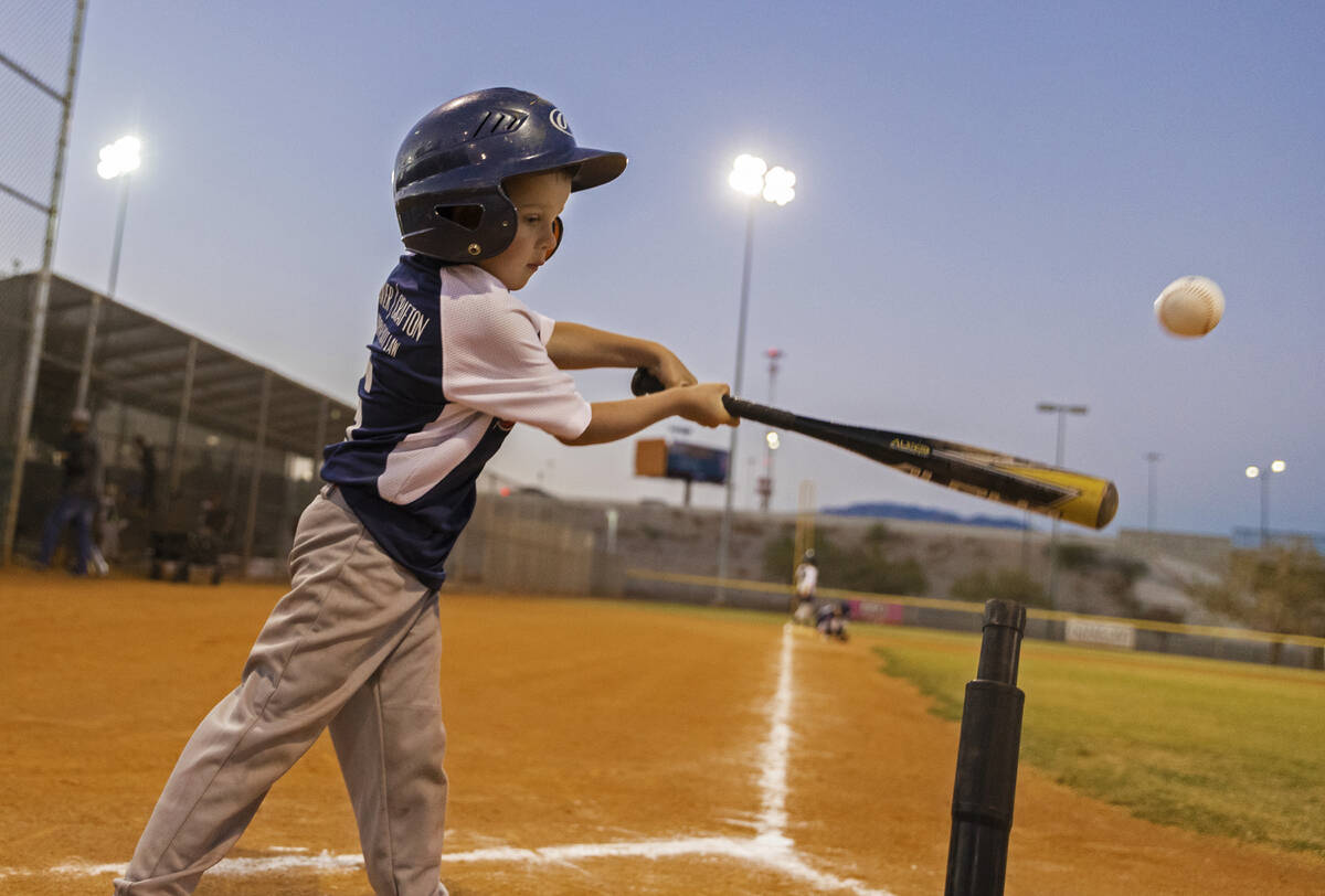 Braves player Mays Mott hits the ball during a tee ball game at Mountain Ridge Little League Pa ...
