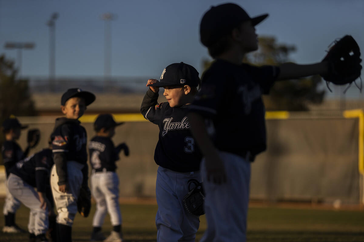 Yankees players warm up before the start of their tee ball game at Mountain Ridge Little League ...