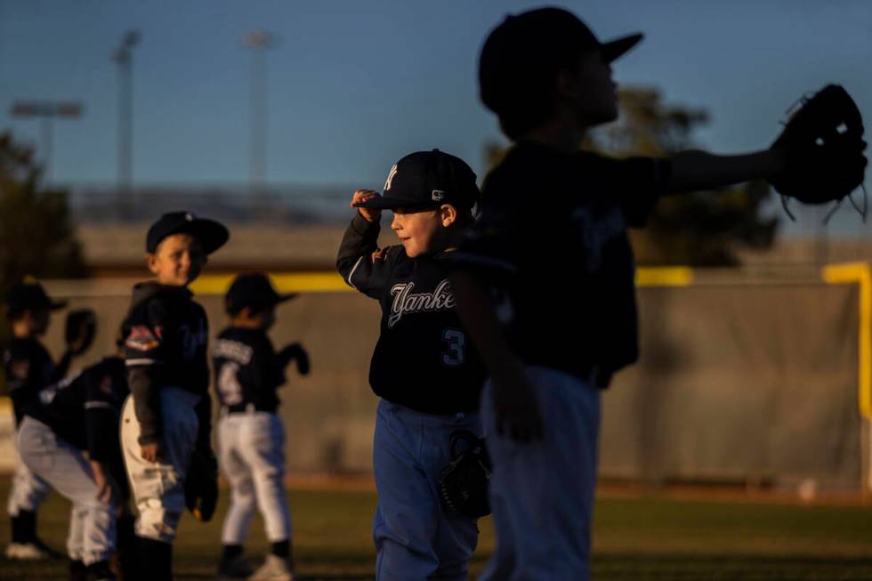 Yankees players warm up before the start of their tee ball game at Mountain Ridge Little League ...