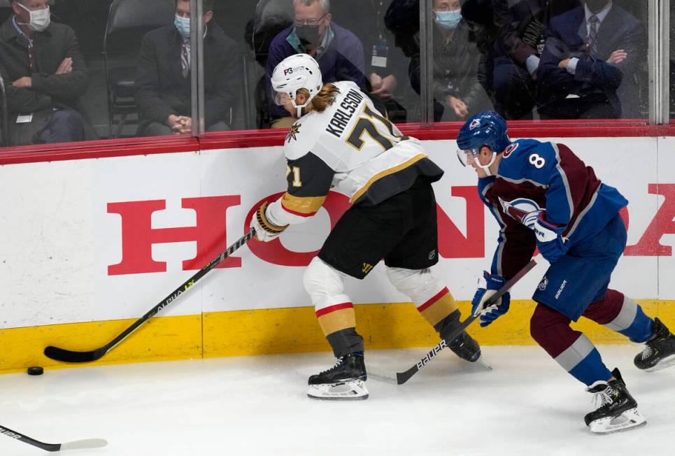 Vegas Golden Knights center William Karlsson, left, reaches out to control the puck as Colorado ...
