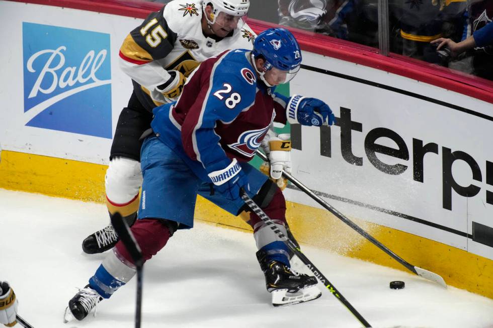 Colorado Avalanche defenseman Ryan Murray, front, fights for control of the puck with Vegas Gol ...