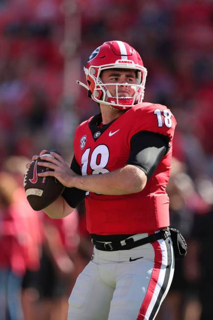 Georgia quarterback JT Daniels (18) warms up before the start of an NCAA college football game ...