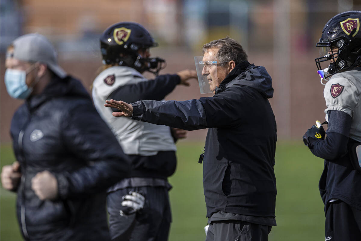In this March 11, 2021, file photo, Faith Lutheran head football coach Mike Sanford leads pract ...