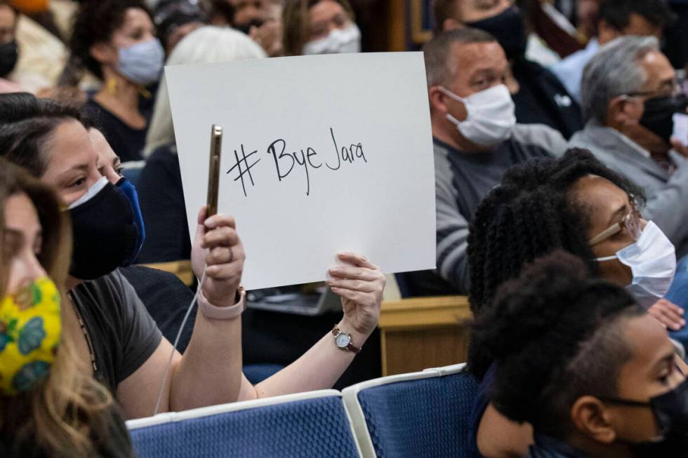 An attendee displays a sign after the board of trustees voted to oust Superintendent Jesus Jara ...