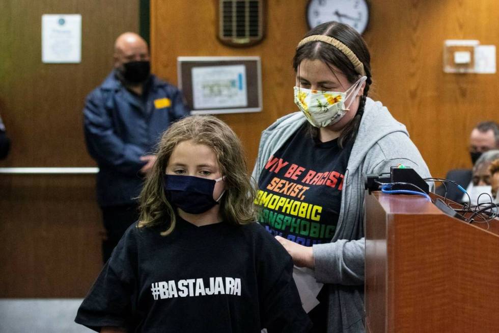 Delilah Schulz, 9, and her mother Sarah Comroe, Rancho High School teacher, leave the podium af ...