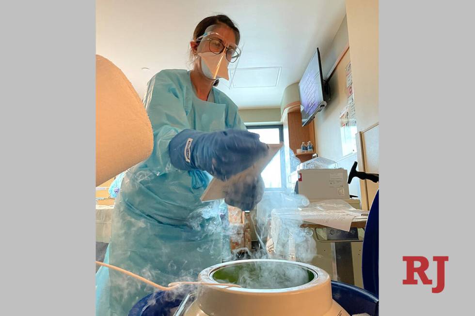 A nurse removes stem cells from storage in liquid nitrogen, where they are kept frozen until ri ...