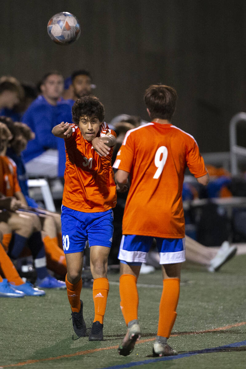 Bishop Gorman's Tayte Lazarski (30) passes from the sidelines next to Caedon Cox (9) during a h ...