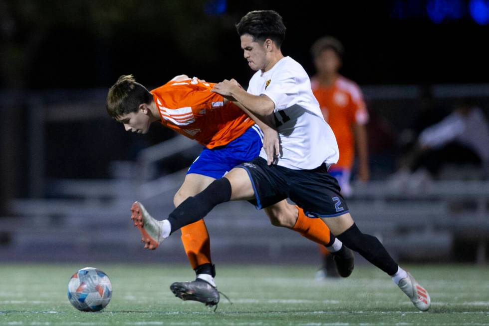 Bishop Gorman's Luke Parker (32) and Las Vegas' Darian Coronel (11) run for the ball during a h ...