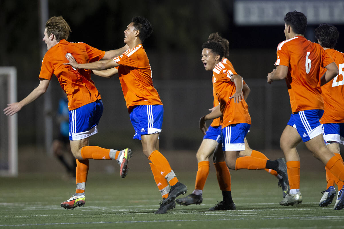 Bishop Gorman's Nathaniel Roberts (8) runs for the bench to celebrate the goal he scored during ...