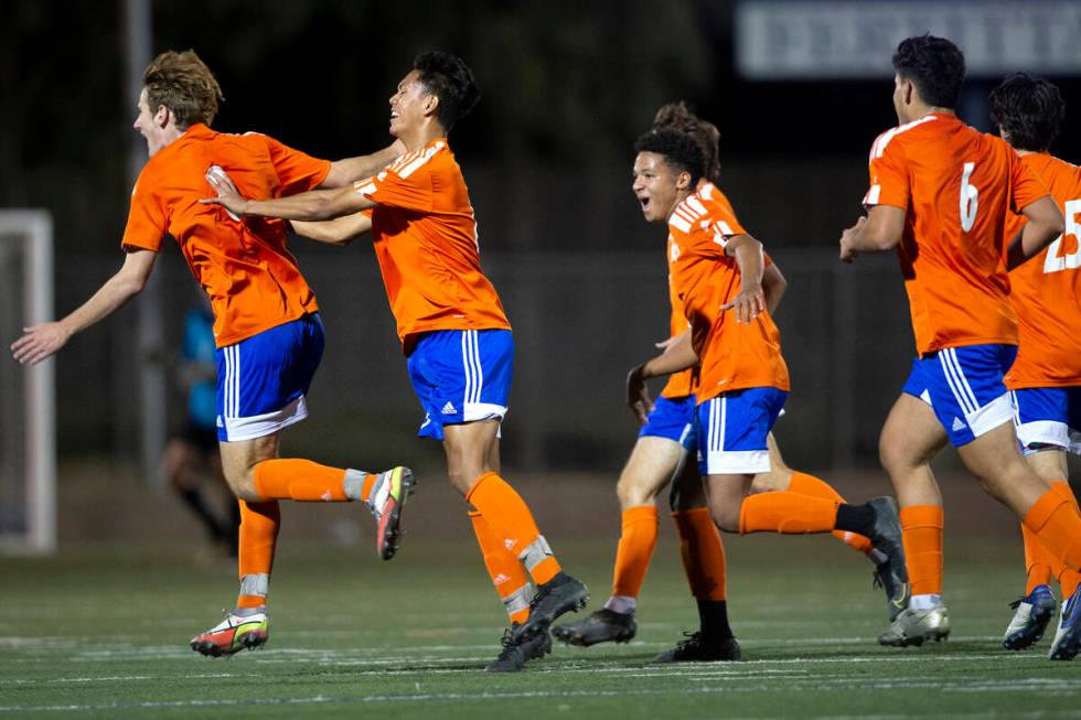 Bishop Gorman's Nathaniel Roberts (8) runs for the bench to celebrate the goal he scored during ...