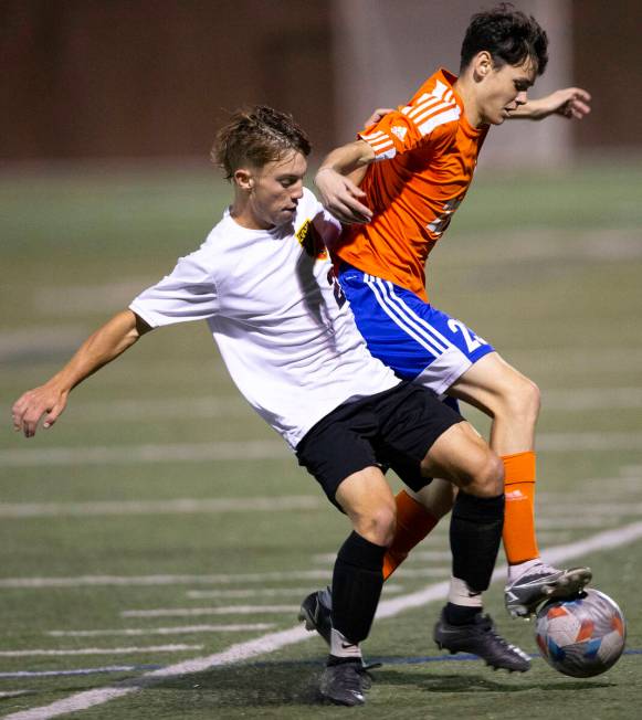 Las Vegas' Cater McCoy (2) and Bishop Gorman's Kole Lippisch (23) compete for the ball during a ...