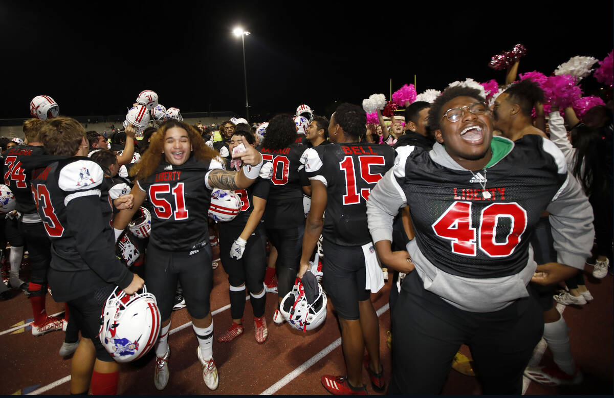 Liberty High School's players celebrate their victory against Legacy High School after a footba ...