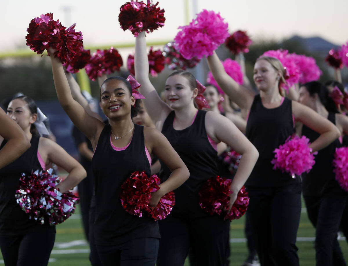Liberty High School's cheerleaders march to the field before a football game against Legacy Hig ...