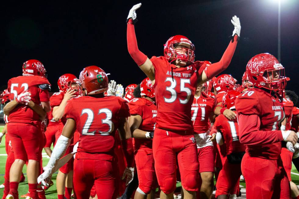 Arbor View players, including Jonathan Stites (35), celebrate a win against Desert Pines in a h ...