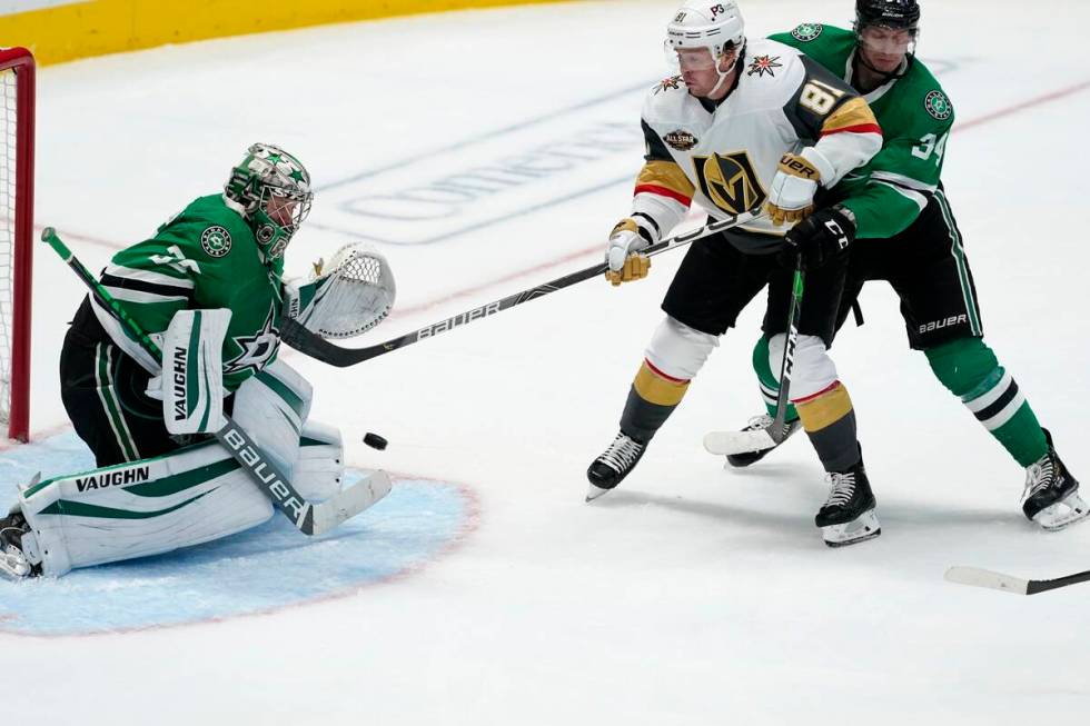 Dallas Stars goaltender Anton Khudobin (35) blocks a shot as right wing Denis Gurianov (34) hel ...