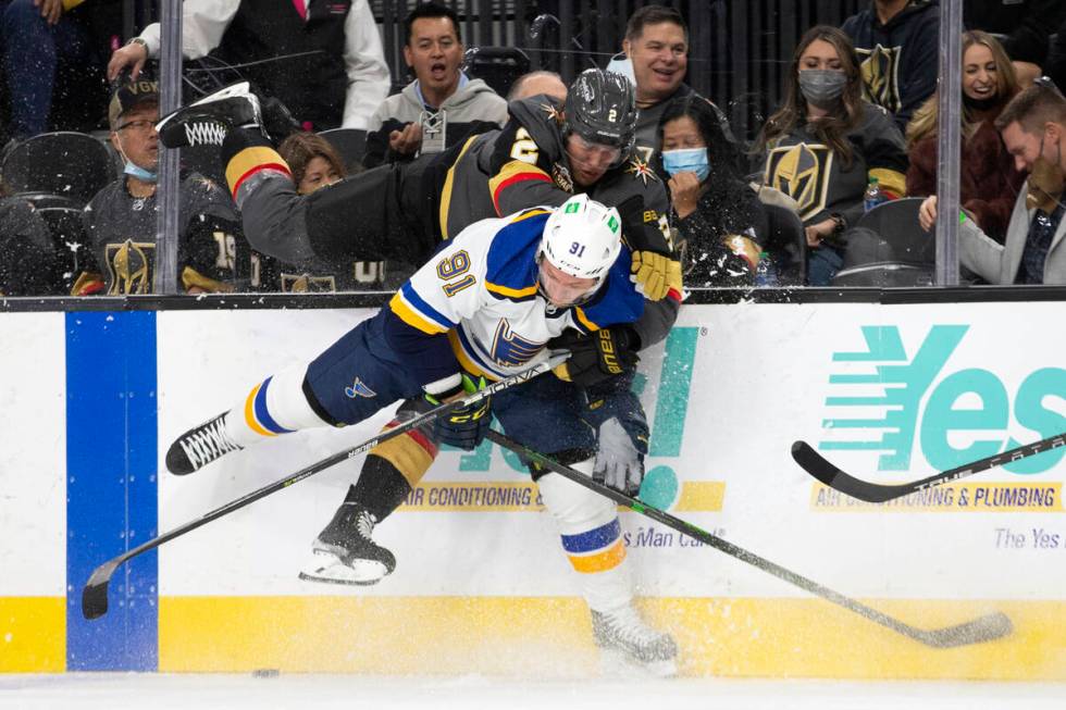 Golden Knights defenseman Zach Whitecloud (2) and Blues right wing Vladimir Tarasenko (91) ...