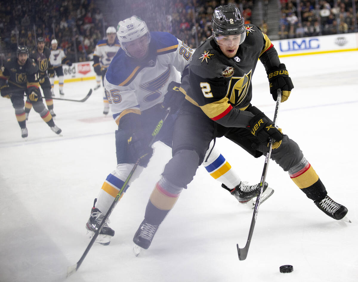 Golden Knights defenseman Zach Whitecloud (2) skates for the puck as Blues center Jordan Kyrou ...