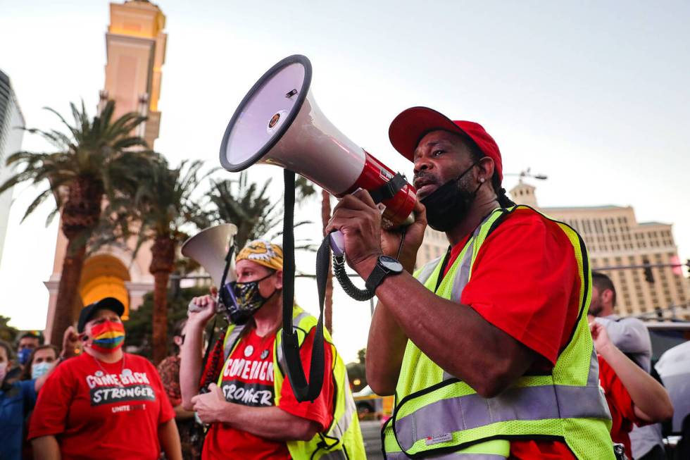 Chad Neanover, left, and James Reed, right, both organizers, cheer on the crowd at a rally of t ...