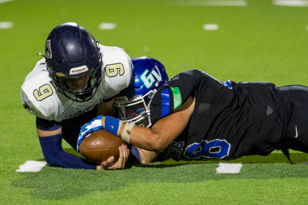 Foothill quarterback Jack Thow (9) recovers a loose ball as Green Valley defensive end Eric Sho ...